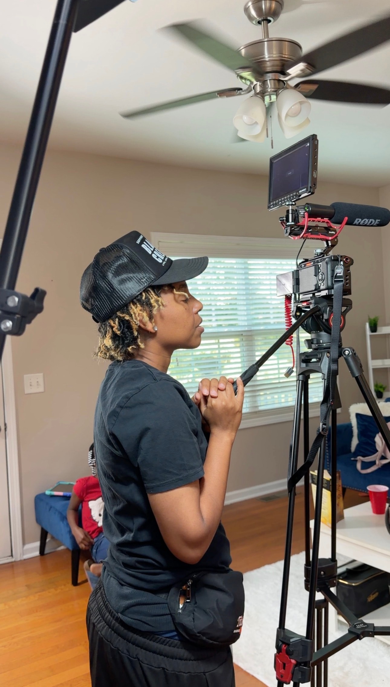 Sheena Lanier operating camera equipment on set
